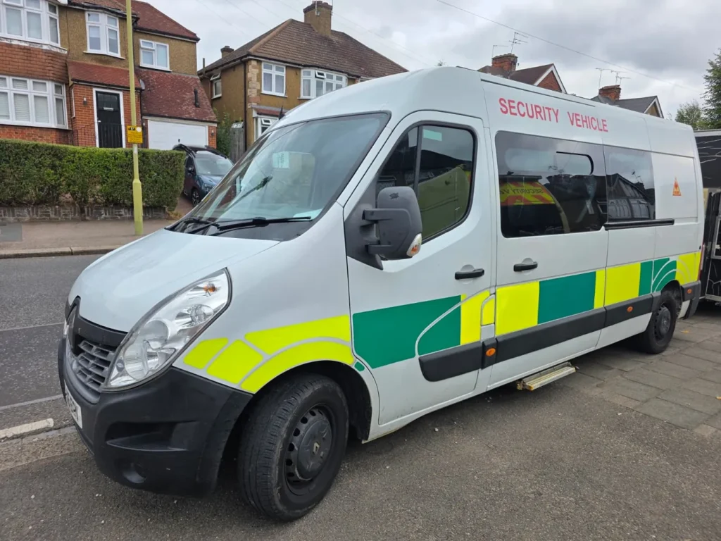 White security van with yellow and green markings